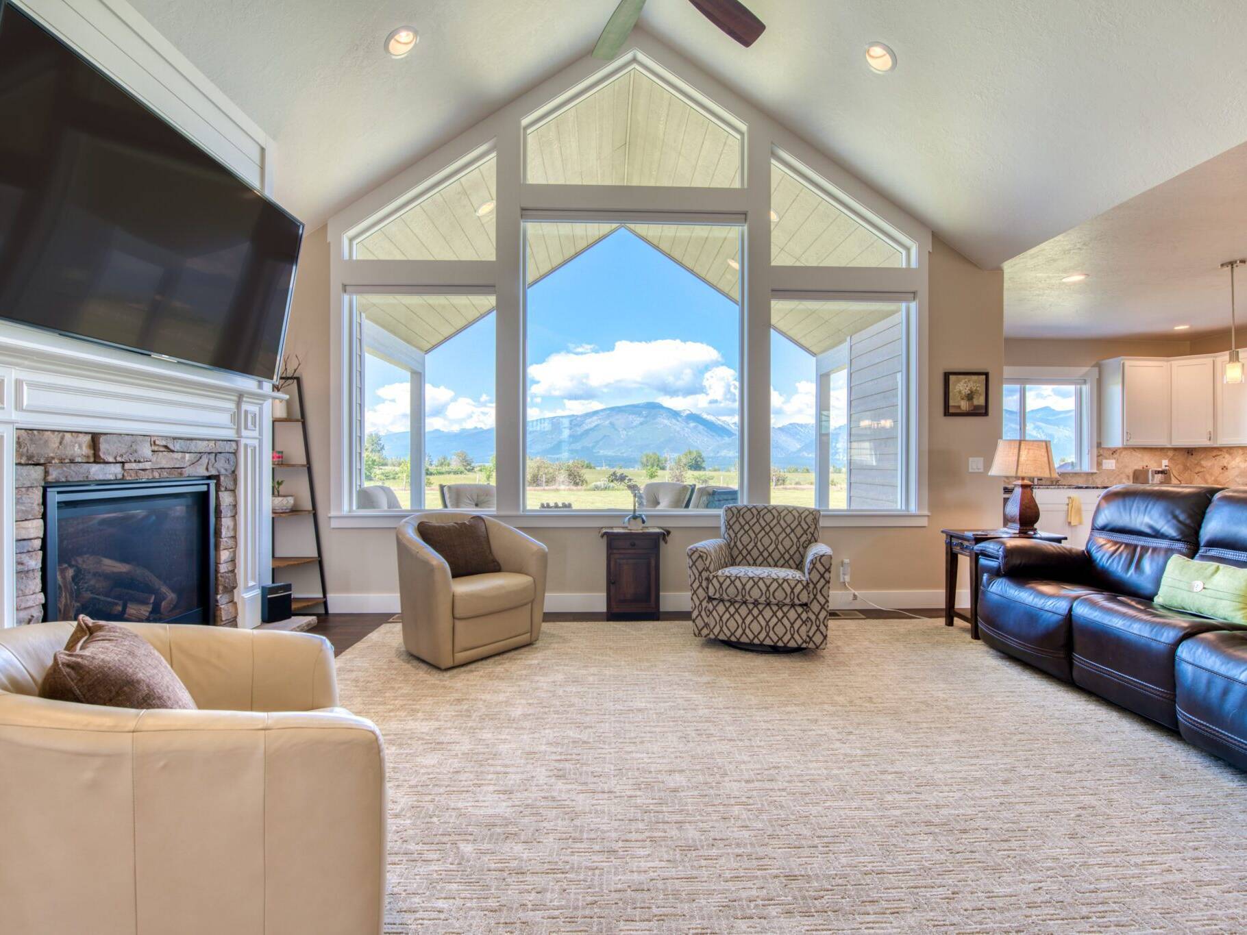 Living room with large windows overlooking the Bitterroot valley in a home built by Big Sky Builders of Montana in Hamilton, MT