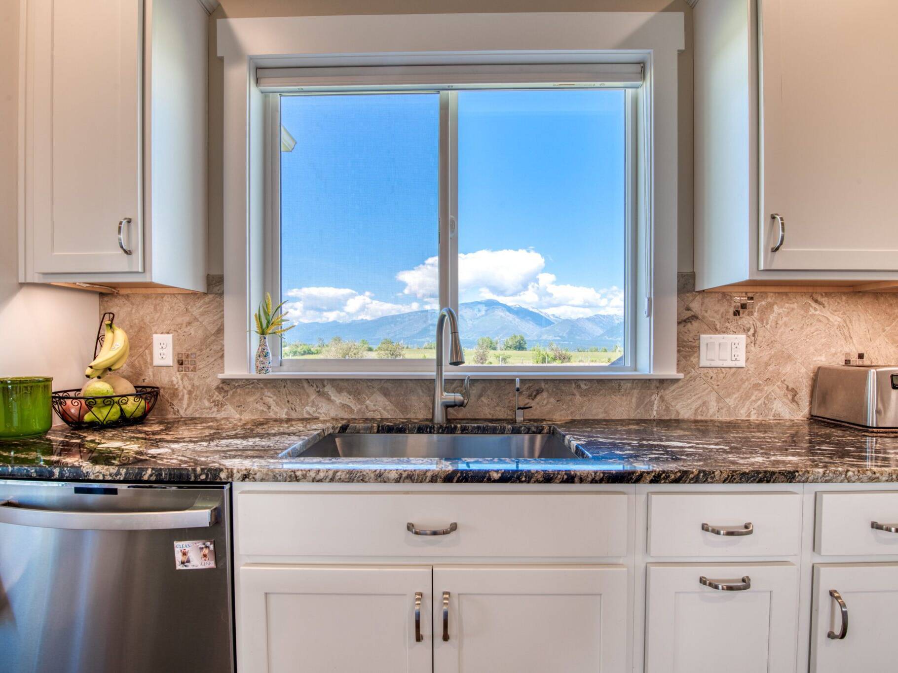 Kitchen sink with window overlooking the Bitterroot valley in a custom home built by Big Sky Builders of Montana in Hamilton, MT