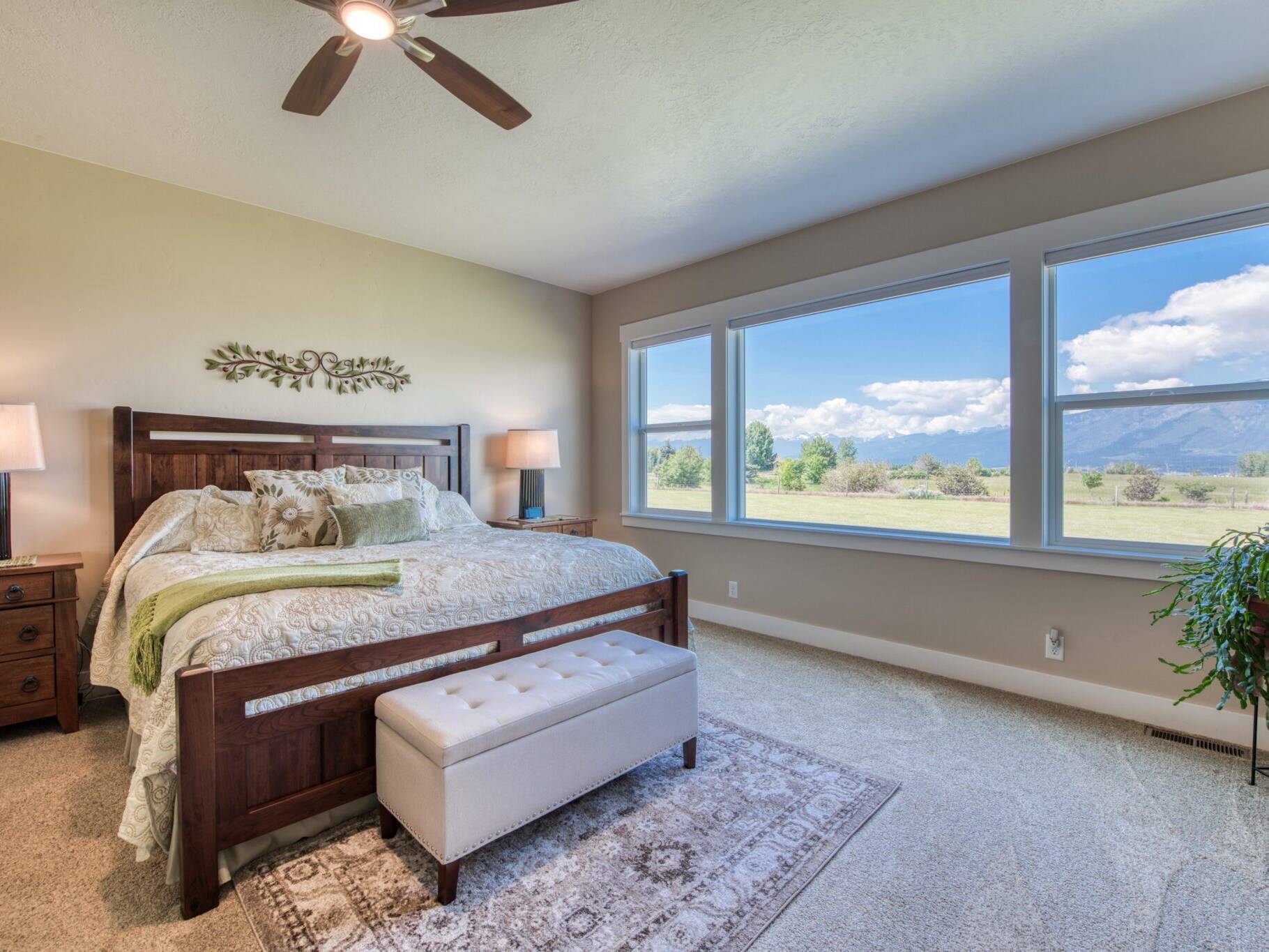 Master bedroom with large window overlooking the Bitterroot valley in a custom home built by Big Sky Builders of Montana in Hamilton, MT