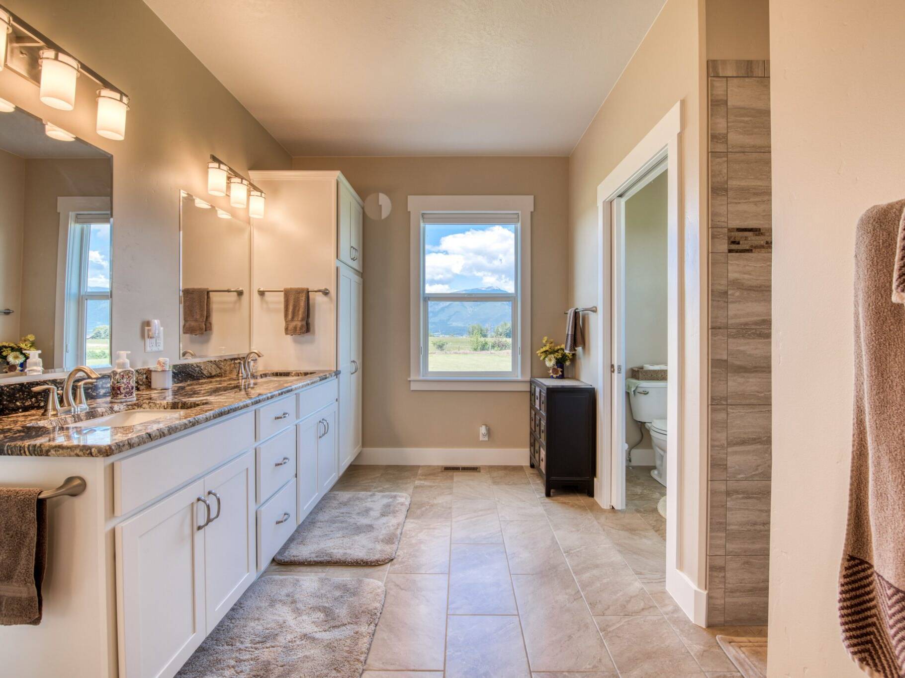 Master bathroom with granite countertops tile shower and tile floor in a custom home built by Big Sky Builders of Montana in Hamilton, MT