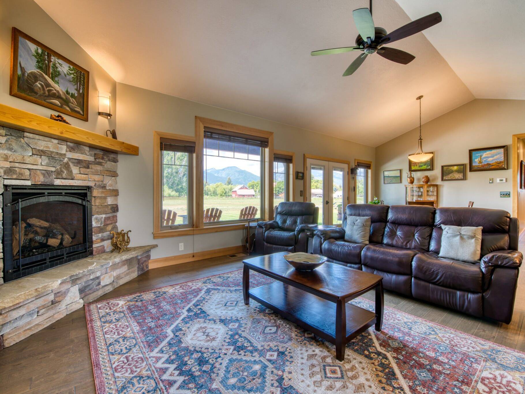 Living room with wood flooring, gas fireplace and wood trim in a custom home in Hamilton, MT