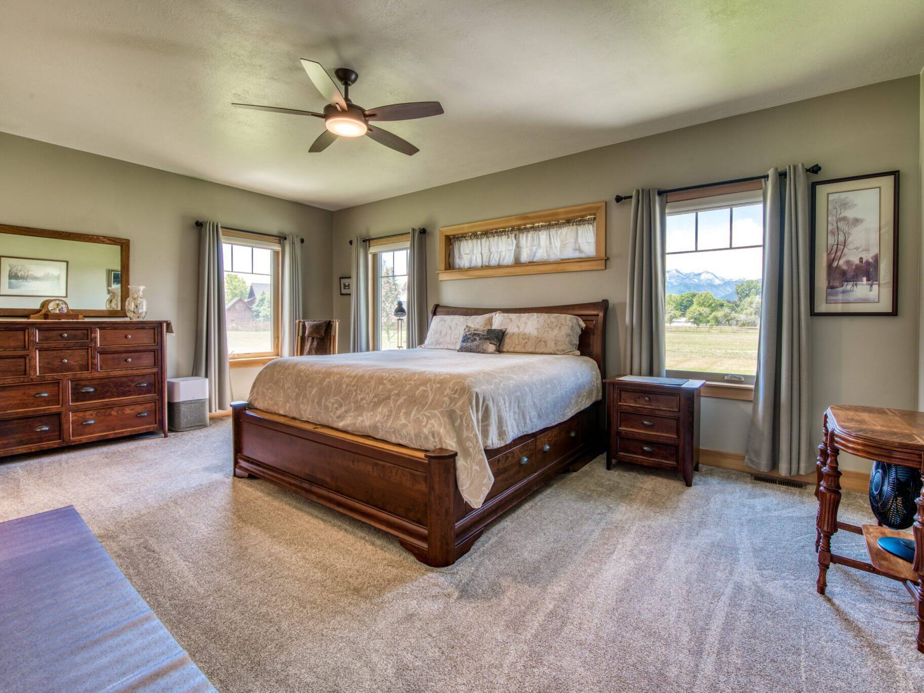 Master bedroom with carpet flooring, wood trim and doors in a custom home near Hamilton, MT.