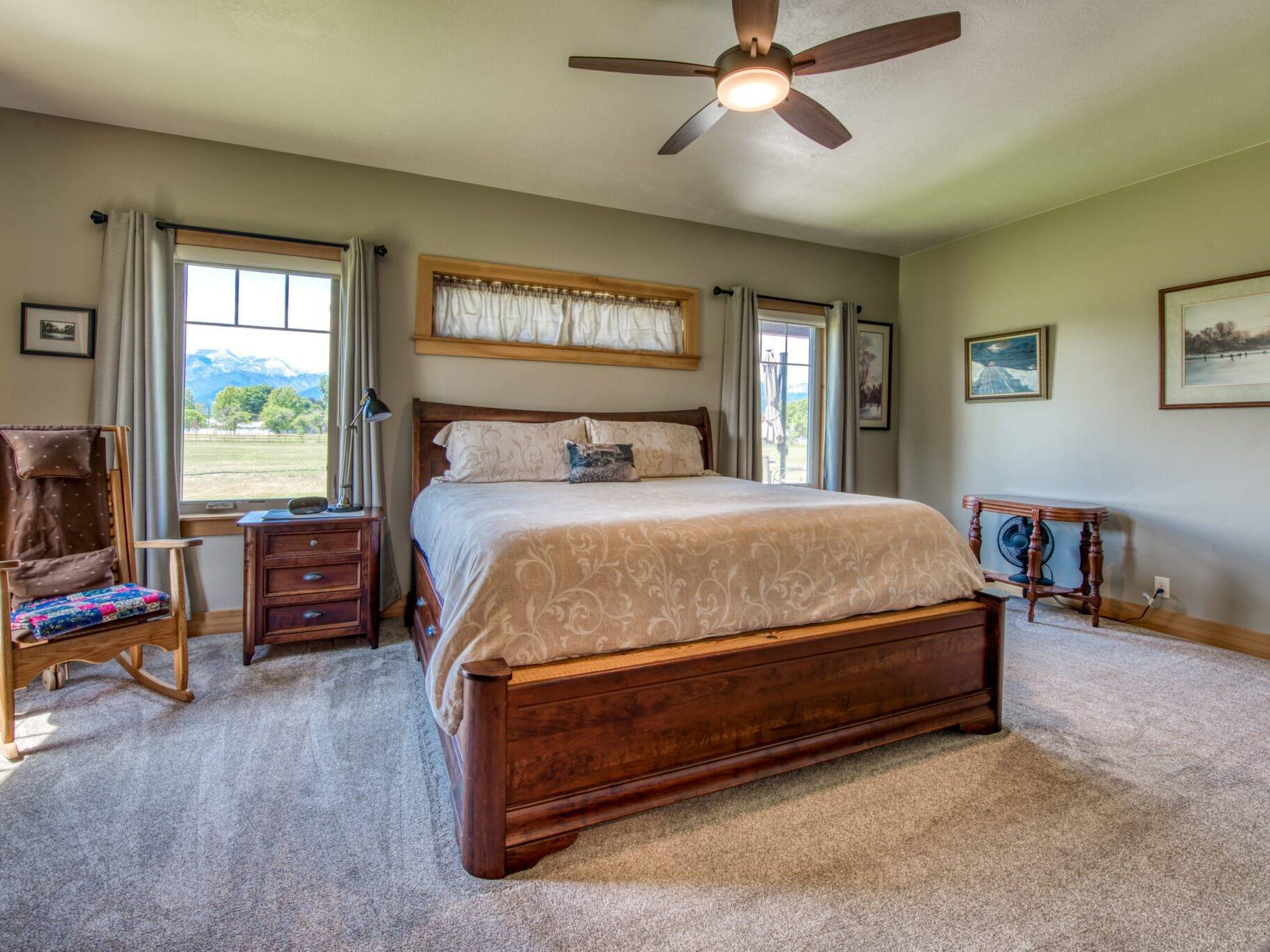 Master bedroom with carpet flooring, wood trim and doors in a custom home near Hamilton, MT.