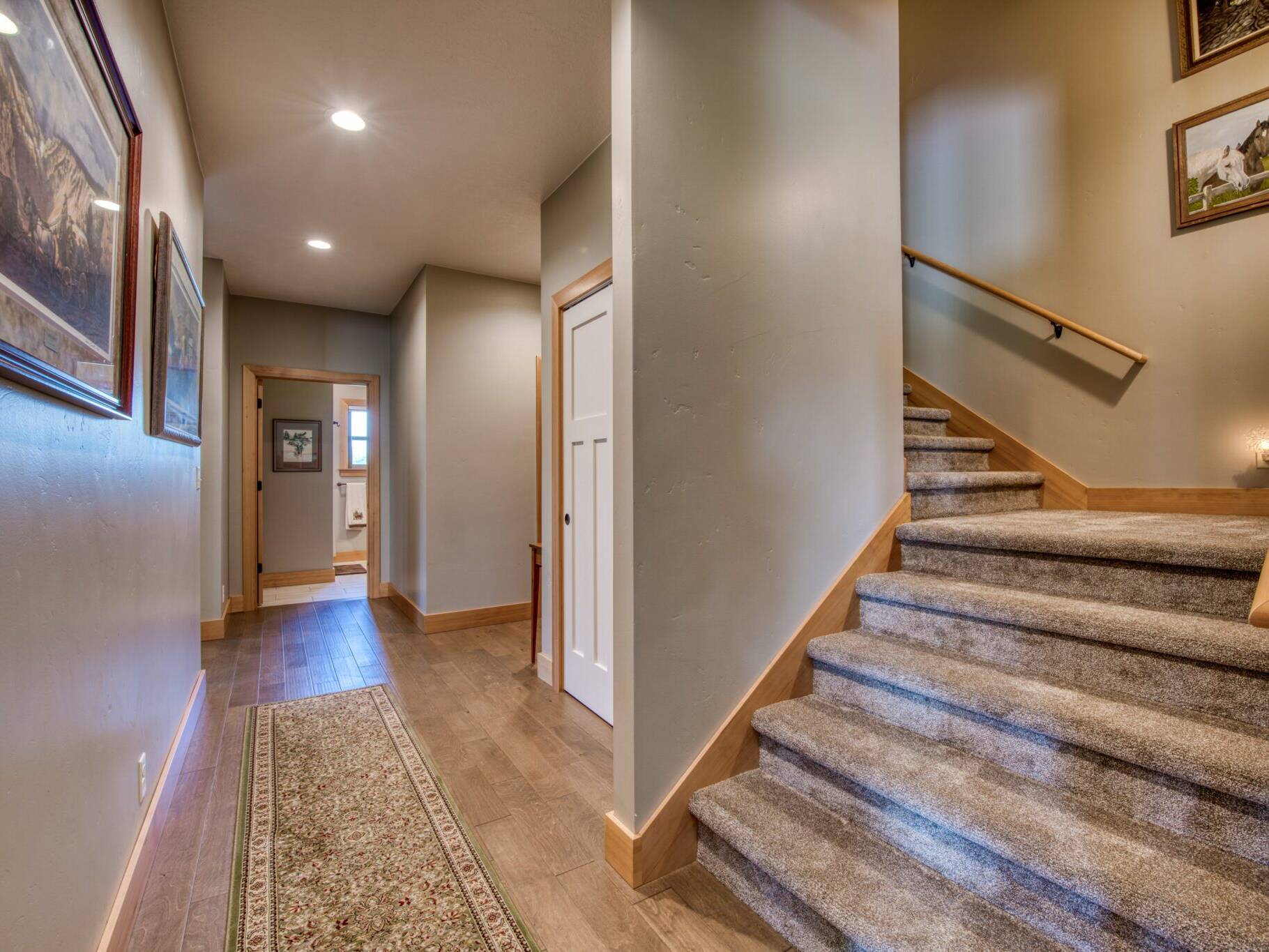 Hallway and carpeted stairs in a custom home near Hamilton, MT.