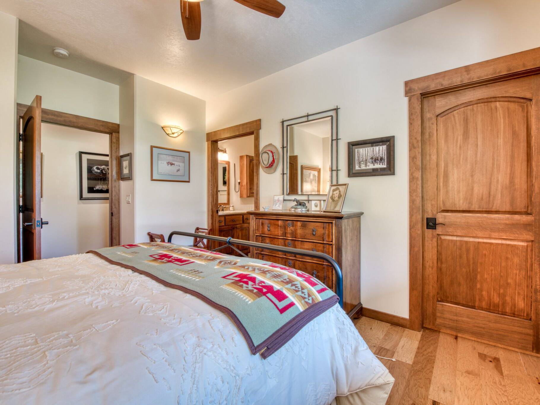 Master bedroom with hardwood floors, and wood trim in a custom home near Hamilton, MT