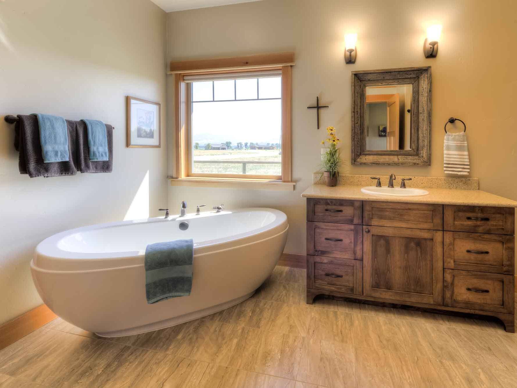 Master bathroom with a freestanding tub and split vanities in a custom home built by Big Sky Builders in Hamilton, Montana