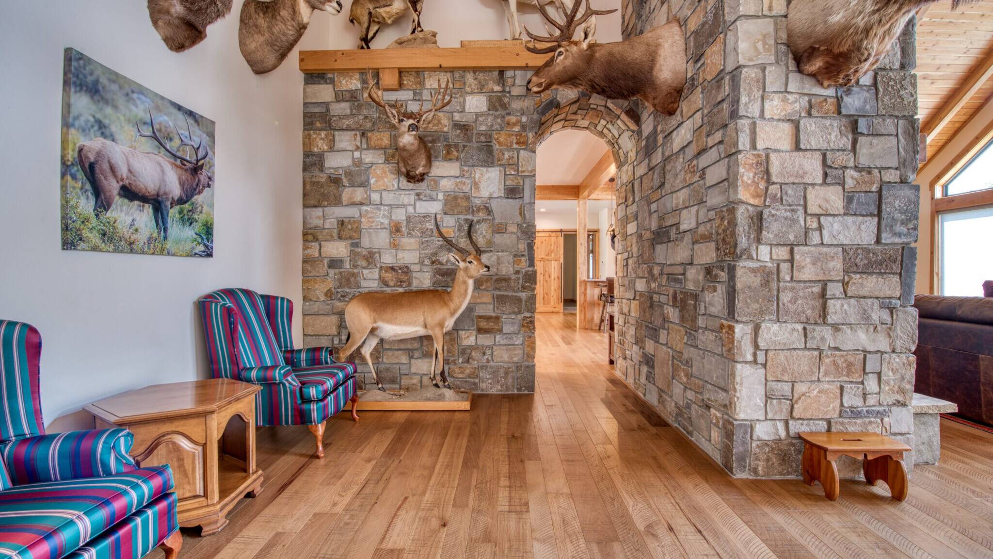 Trophy room with stone archway in a custom home built by Big Sky Builders of Monana in Florence, MT