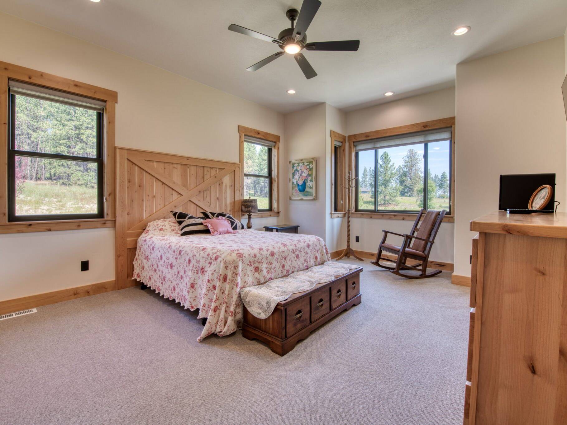 Bedroom with rustic alder trim and doors in a custom home built by Big Sky Builders of Montana in Florence, MT