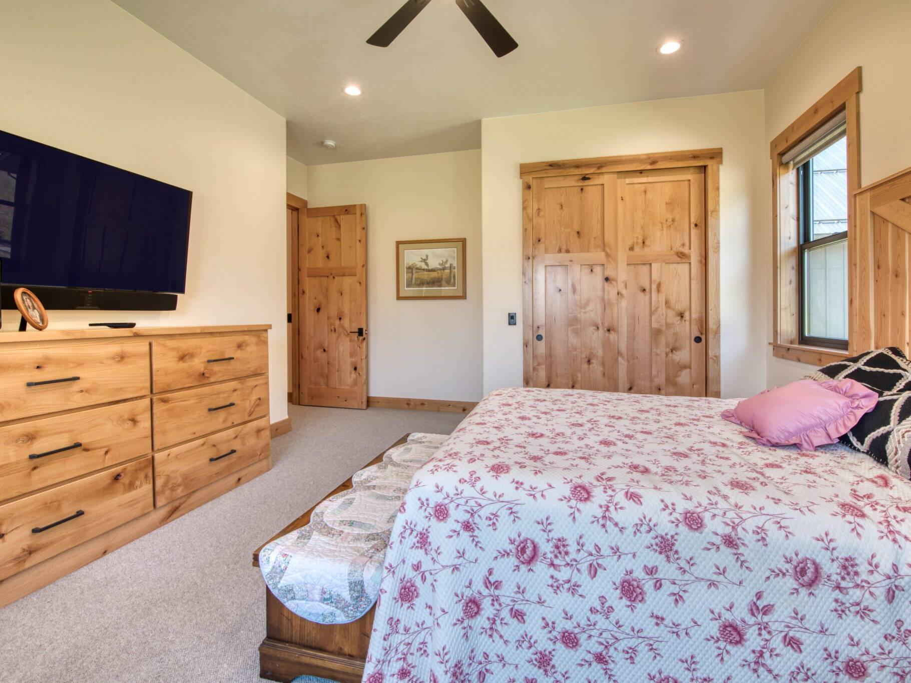 Bedroom with rustic alder trim and doors in a custom home built by Big Sky Builders of Montana in Florence, MT