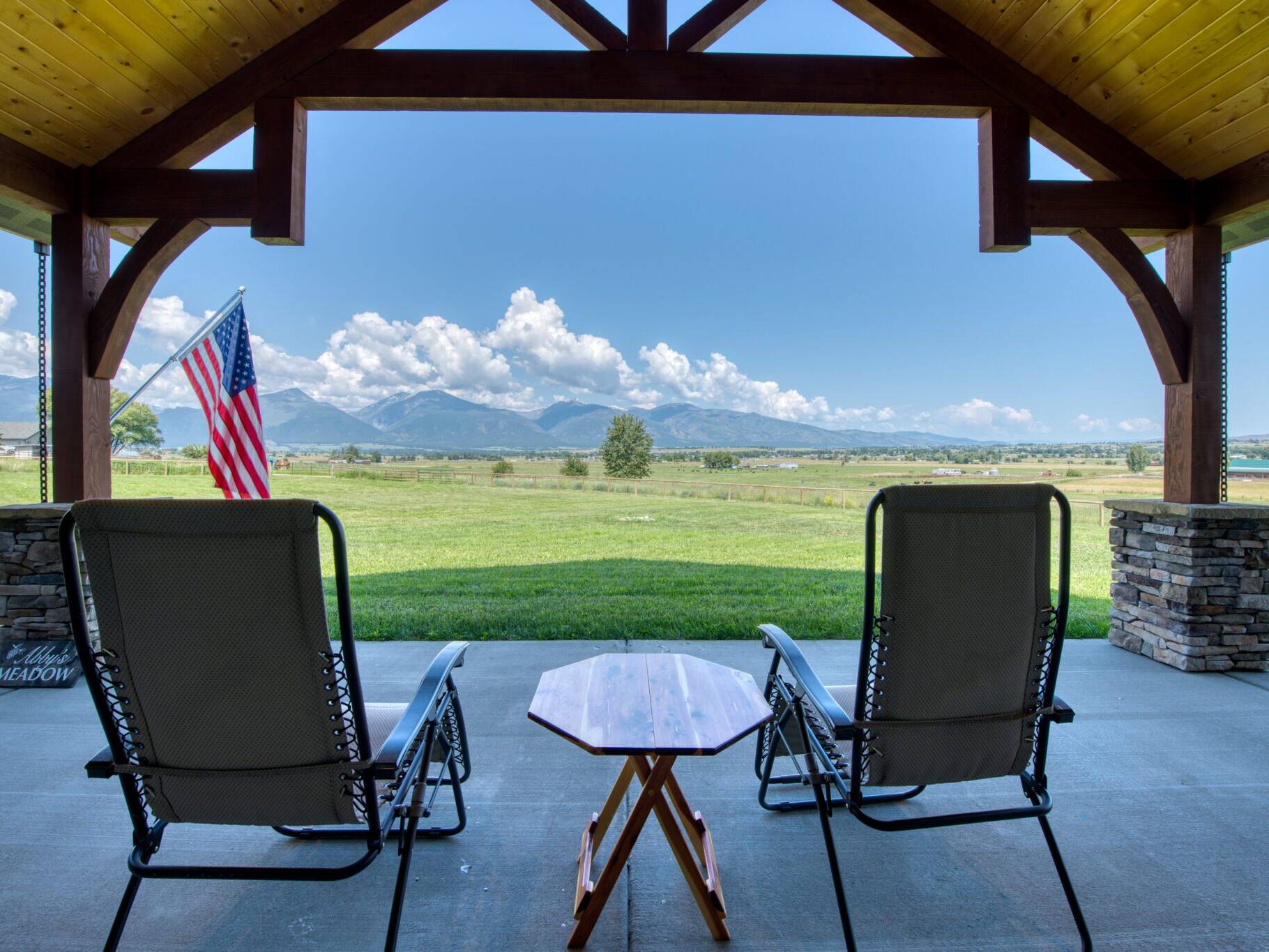 Covered back patio with stunning views on a custom home built by Big Sky Builders in Stevensville, MT