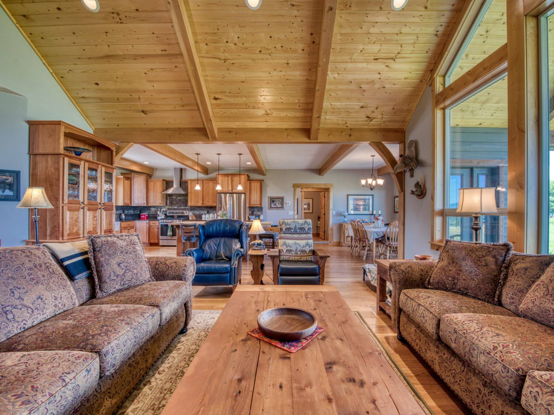 Great room with vaulted T&G pine ceiling with wood beams in a custom home built by Big Sky Builders in Stevensville, MT
