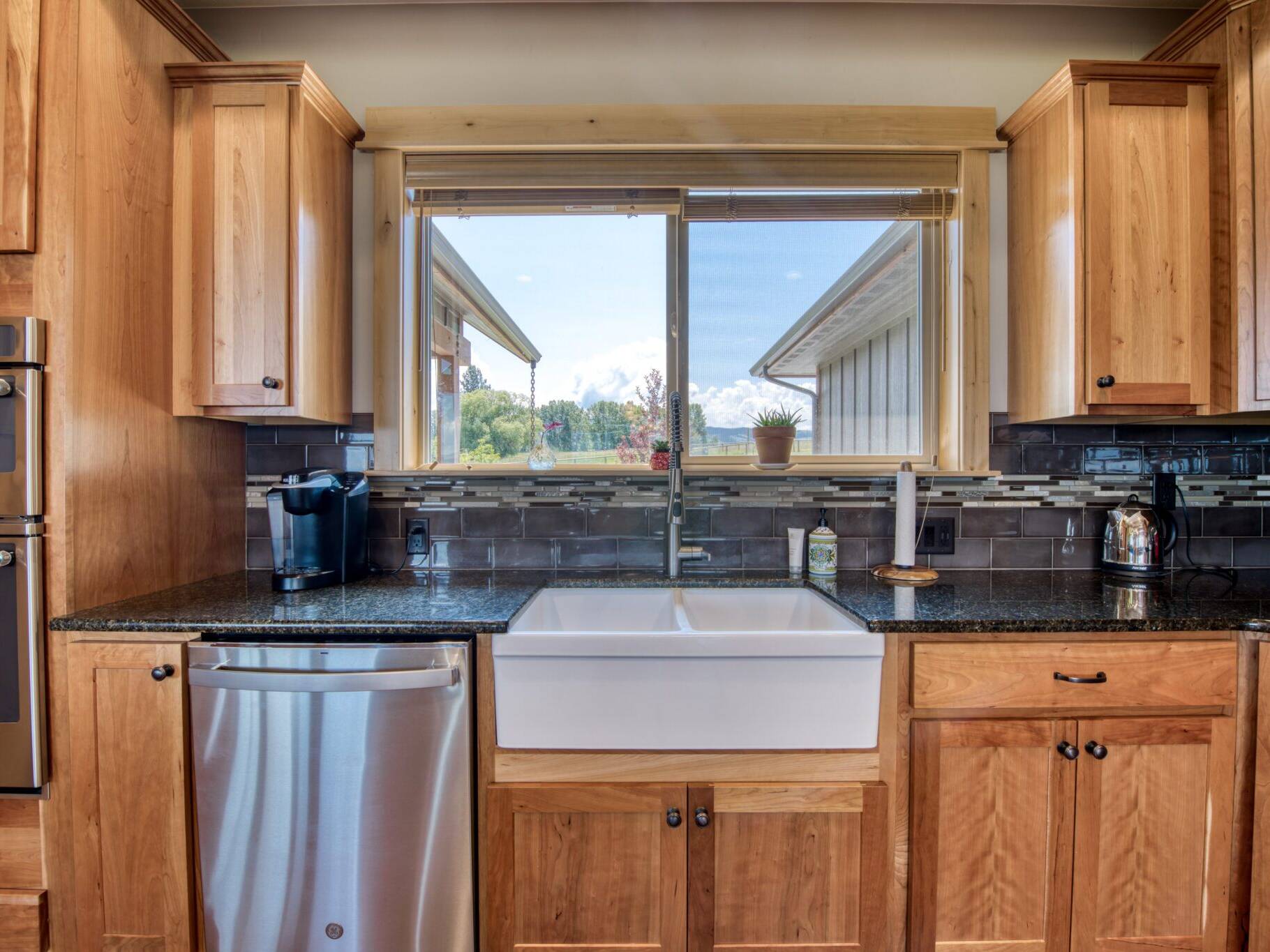 Kitchen farm sink with tile backsplash in a custom home built by Big Sky Builders in Stevensville, MT