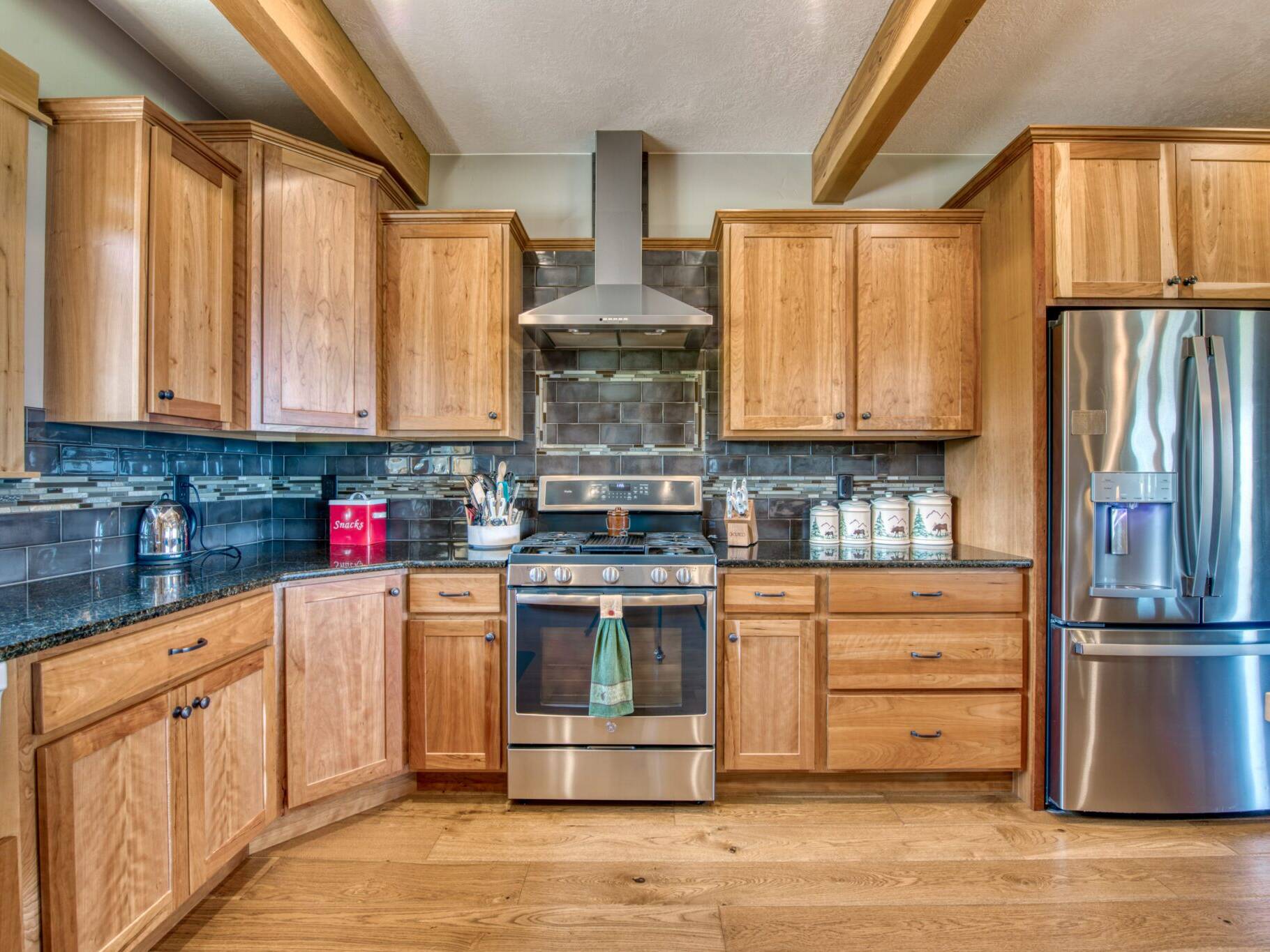 Kitchen gas range with tile backsplash in a custom home built by Big Sky Builders in Stevensville, MT