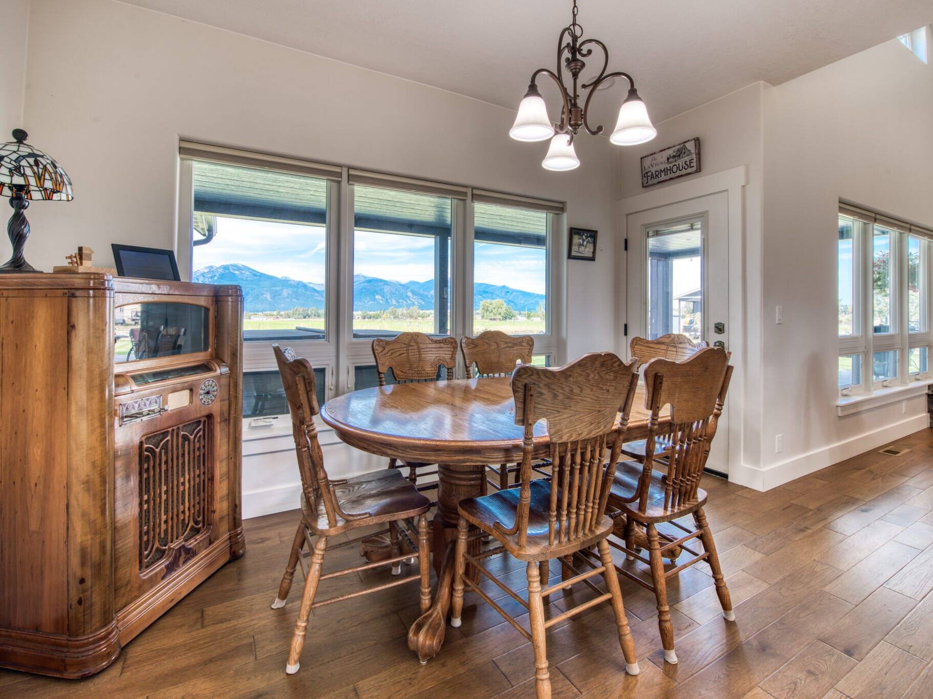 Dining room with wood floors and large windows in a custom home built by Big Sky Builders in Stevensville, MT