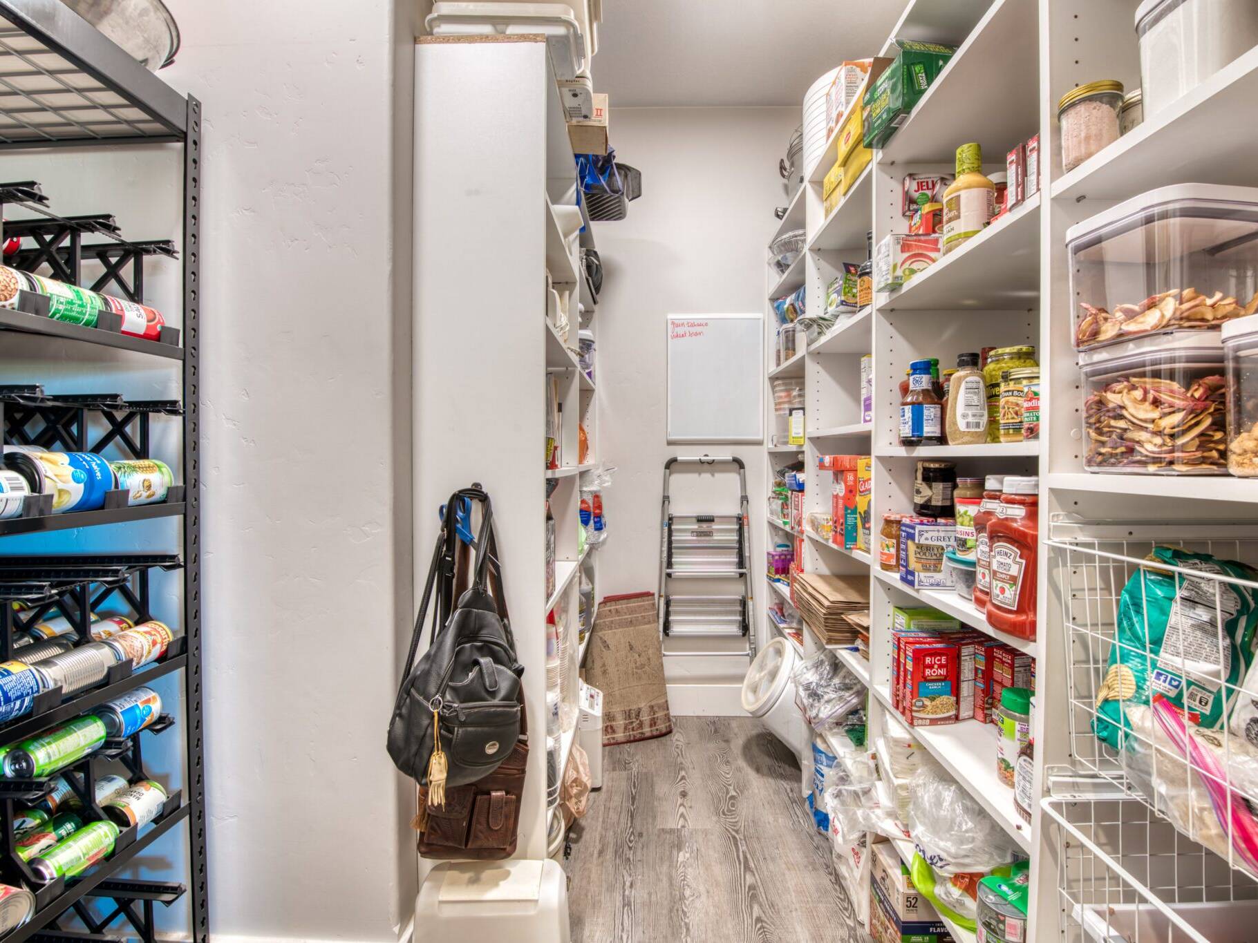 Large pantry with adjustable shelving and LVP flooring in a custom home built by Big Sky Builders in Stevensville, MT