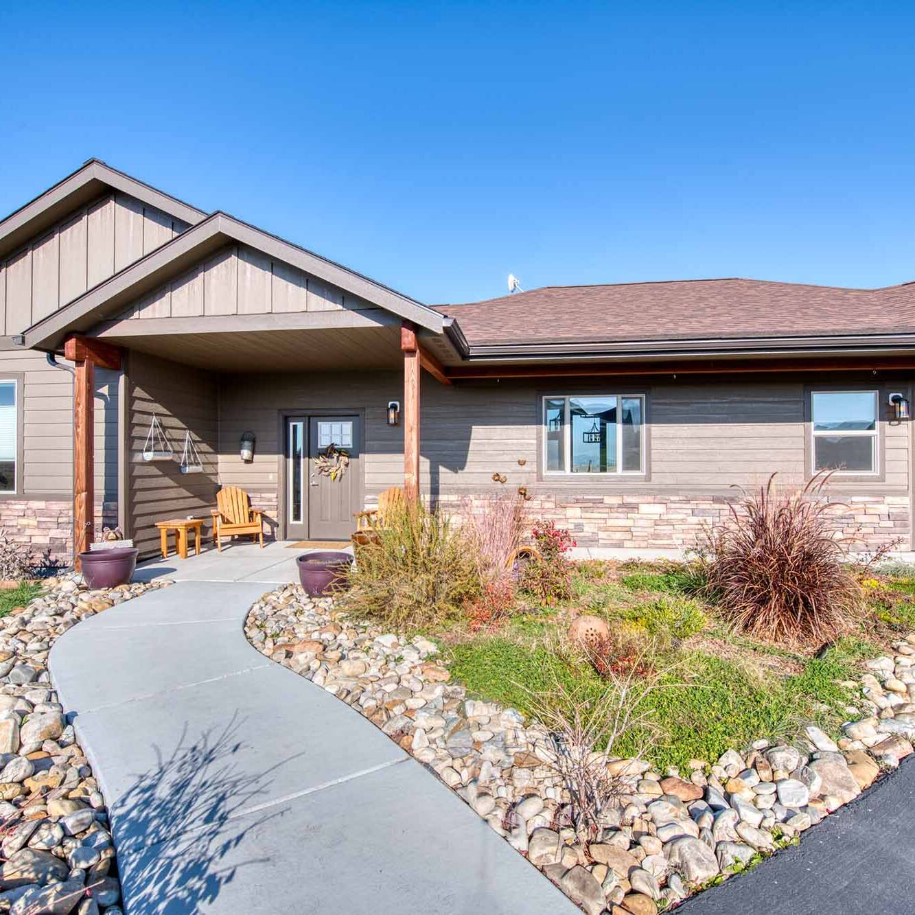 Front exterior & entry porch of The Copper Creek model home - Built by Big Sky Builder in Florence, MT