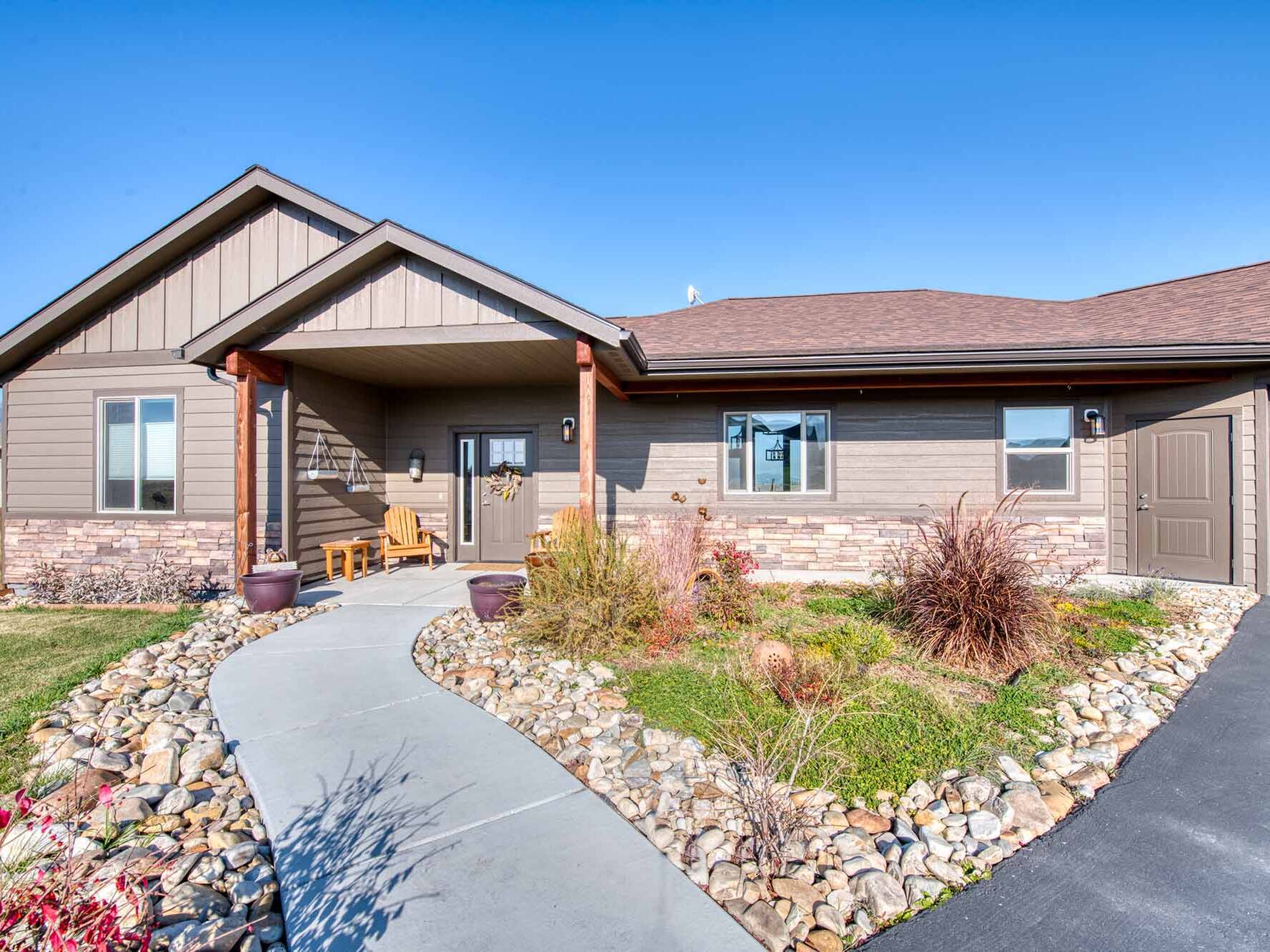 Front exterior & entry porch of The Copper Creek model home - Built by Big Sky Builder in Florence, MT