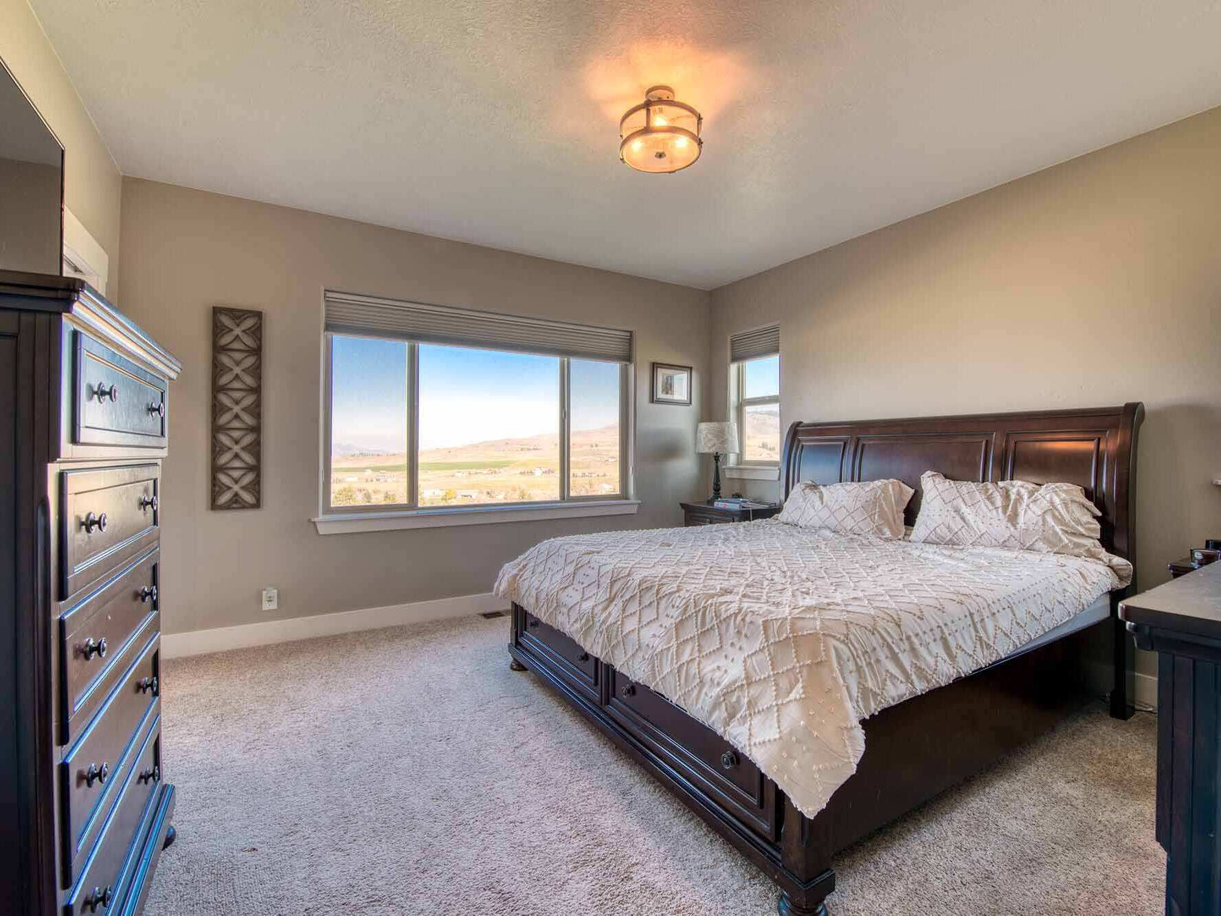 Master bedroom in The Copper Creek model home - Built by Big Sky Builder in Florence, MT