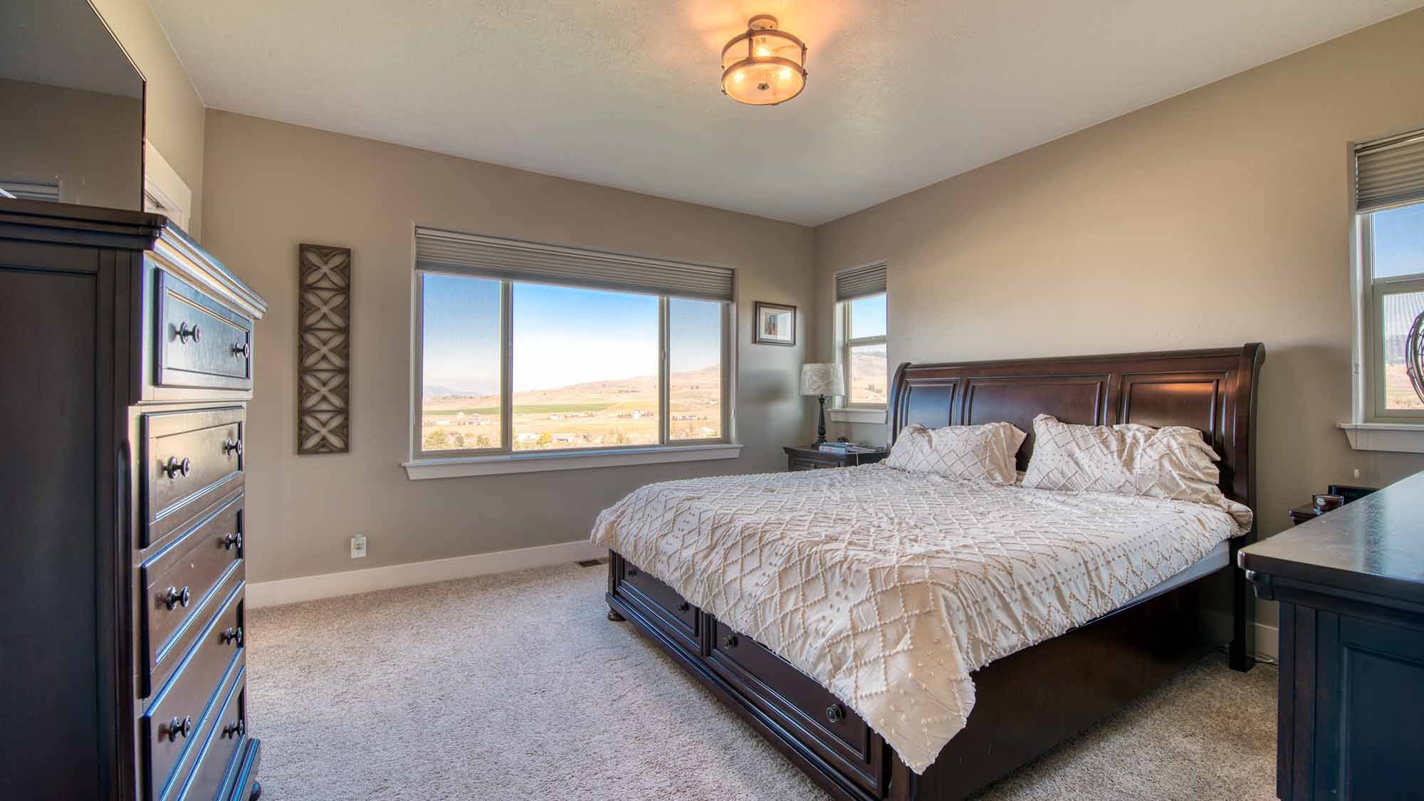 Master bedroom in The Copper Creek model home - Built by Big Sky Builder in Florence, MT