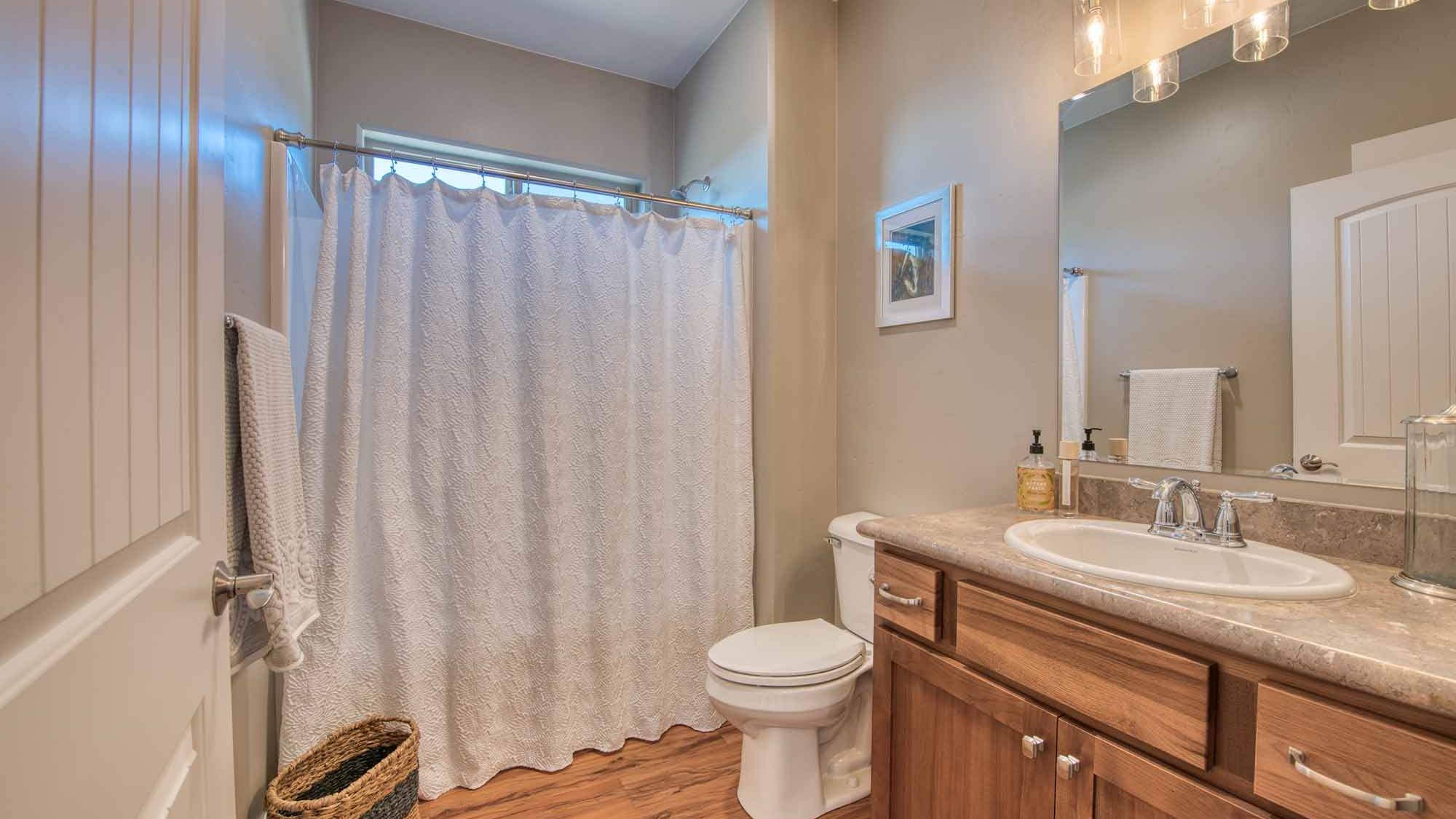 Guest bathroom in The Copper Creek model home - Built by Big Sky Builder in Florence, MT