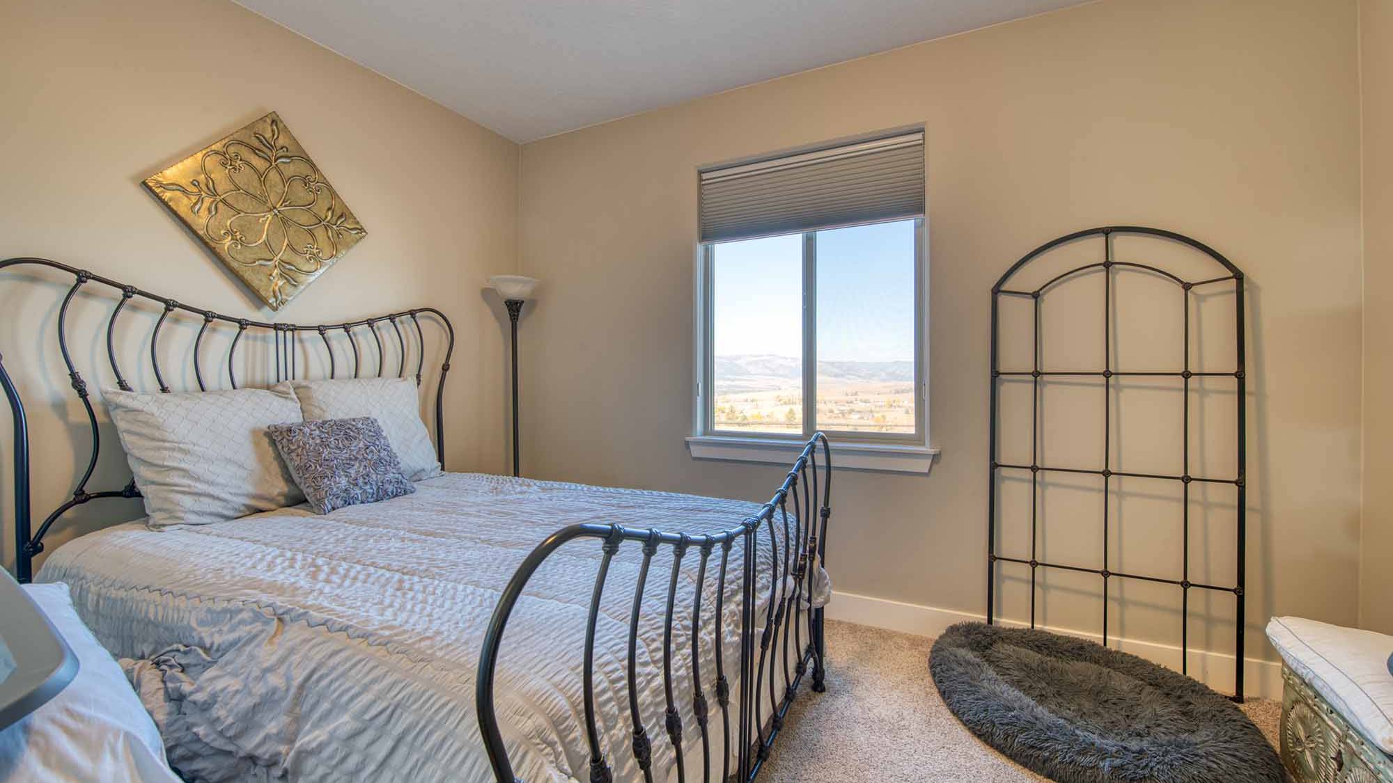 Guest bedroom in The Copper Creek model home - Built by Big Sky Builder in Florence, MT
