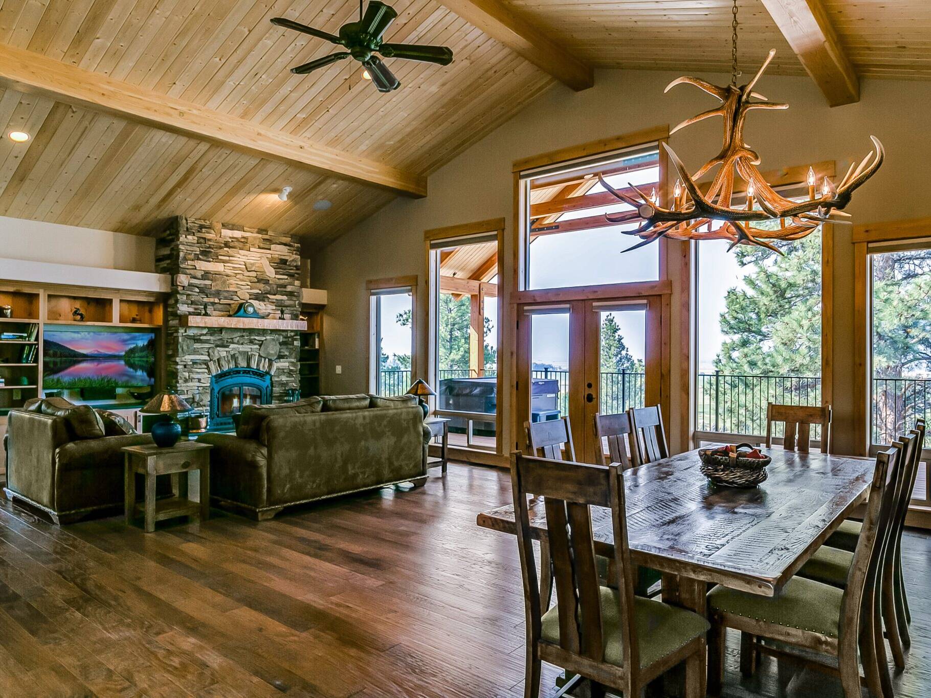 Great room with vaulted ceiling, T&G pine & beams in a custom home built by Big Sky Builders near Stevensville, Montana